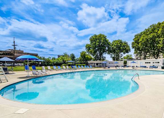 A large outdoor swimming pool with sun loungers at Premier at Cherry Hill, Cherry Hill, New Jersey