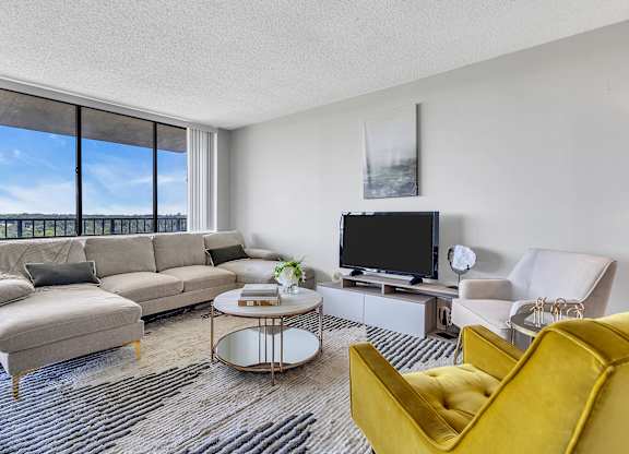 Living room with couch and table at PREMIER @ CITY LINE, Philadelphia