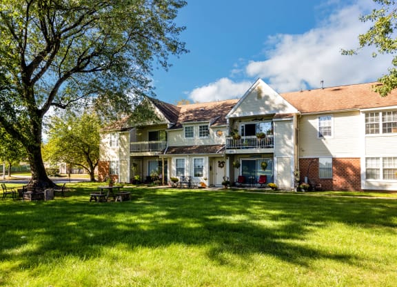 a large white house with a yard in front of it