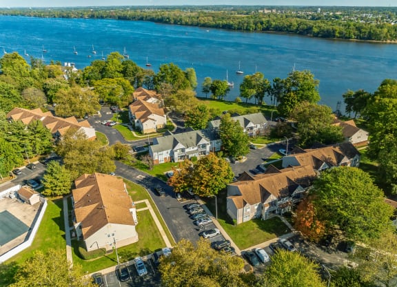 an aerial view of a neighborhood with a lake in the background