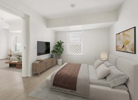 A bedroom with a large bed and a television.