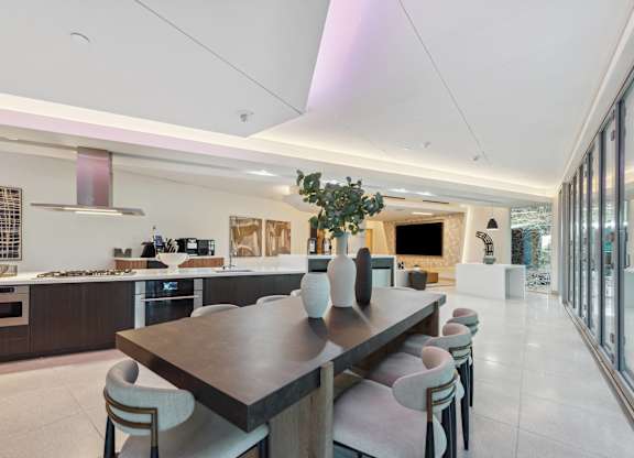 Large dining room with a long table and chairs at K1 Apartments, California, 92101