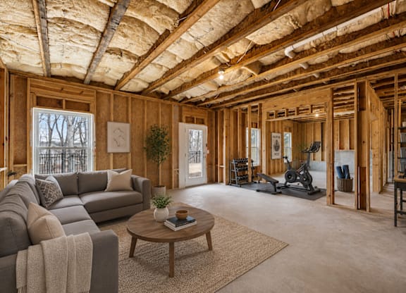 A living room with a grey couch and a coffee table.