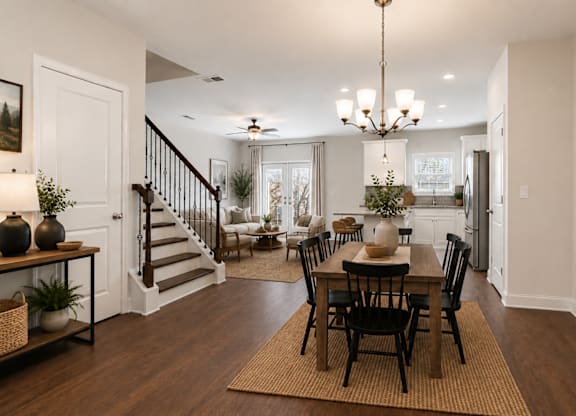 A view of the spacious kitchen, dining area, and stainless steel appliances