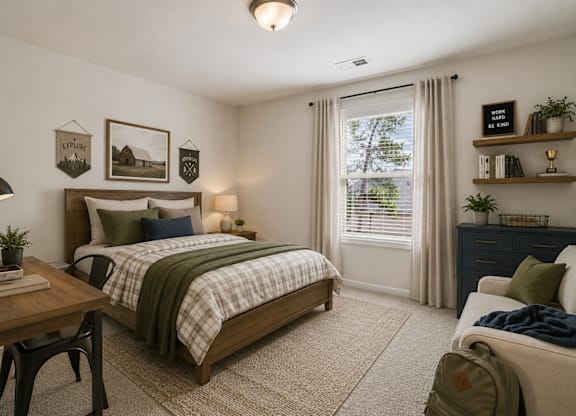Guest bedroom featuring a queen bed with a dedicated desk and chair workspace.