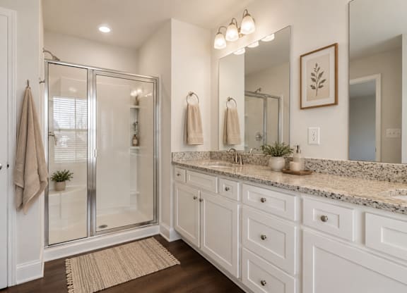 Primary Suite featuring a walk in shower.