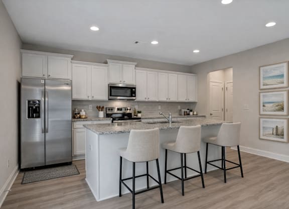Spacious kitchen with an island, ample storage, and stainless steel appliances.