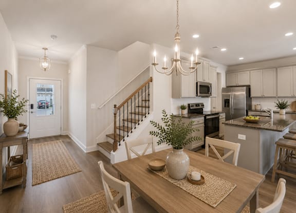 A view of the spacious kitchen, dining area, and stainless steel appliances