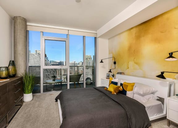 Master bedroom with large windows at K1 Apartments, San Diego, CA