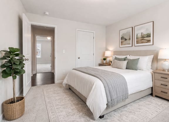 Secondary bedroom with queen size bed and large window letting in a ton of natural light.