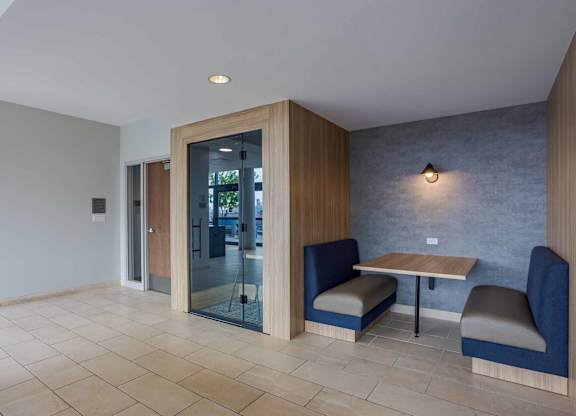 A room with a table and chairs and a glass door.
