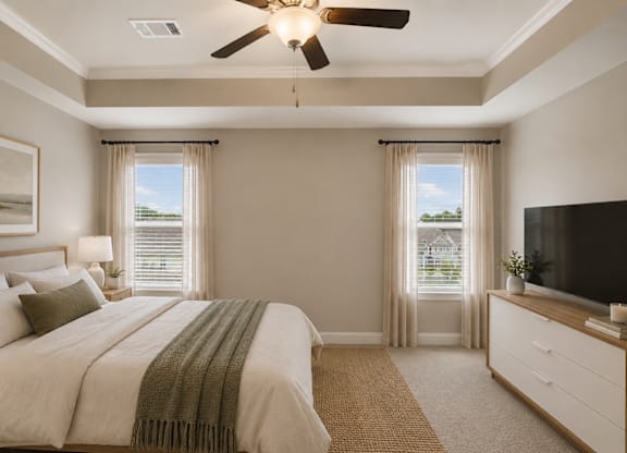 A bedroom with a large bed and a flat screen TV on the side.