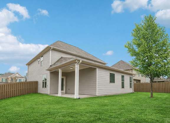 A house with a tree in front of it.