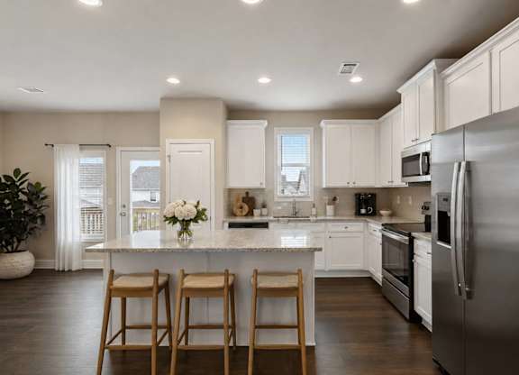 A kitchen with a white countertop and stainless steel appliances.