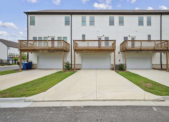 A two-story apartment building with a balcony on each floor.