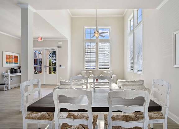 A dining room with a table and chairs.