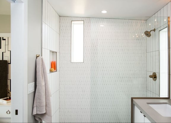 a white bathroom with a shower and a sink at Novella Arcadia, Arizona
