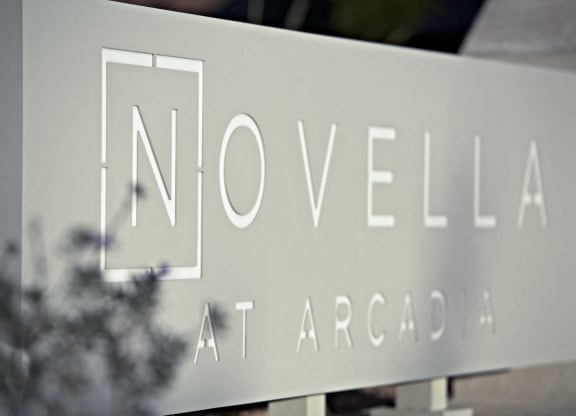 a sign for novella in front of a building at Novella Arcadia, Phoenix, AZ 85018