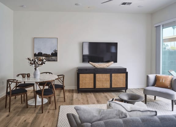 a living room with a couch and a table and a television at Novella Biltmore, Arizona, 85016