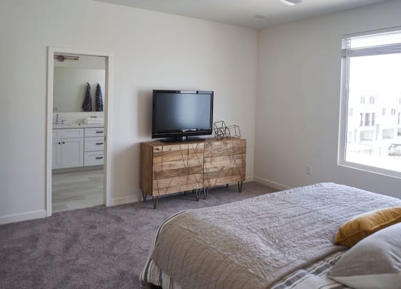 a bedroom with a bed and a television on a dresser at Novella Biltmore, Arizona, 85016