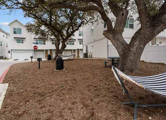 Courtyard with hammocks and benches at Villae ATX Luxury Rental Townhomes, Manchaca, TX