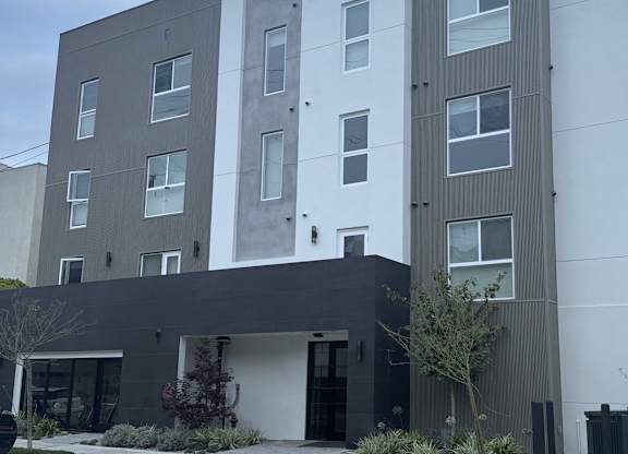 A modern building with a mix of grey and white exterior.