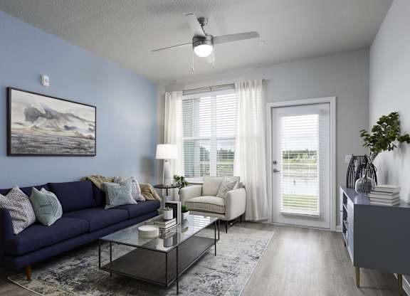 an open living room with a blue couch and a coffee table