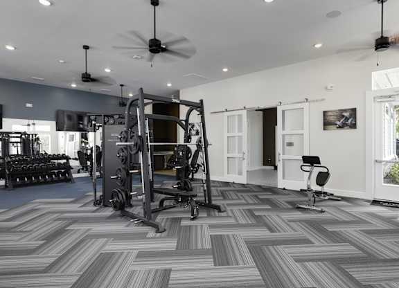 a home gym with exercise equipment and a chevron tile floor