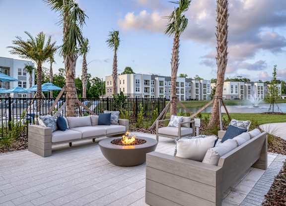 Firepit surrounded by resident and guest seating area.