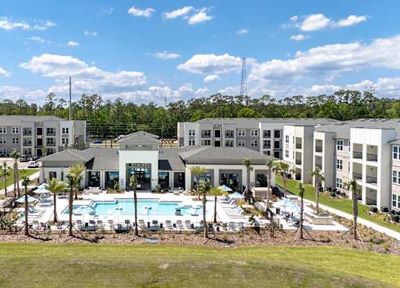 A large building complex with a pool in the middle.