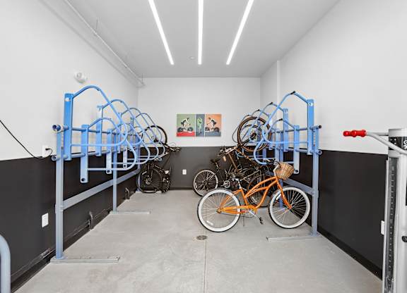 A bike repair shop with bikes on stands and a repair stand.