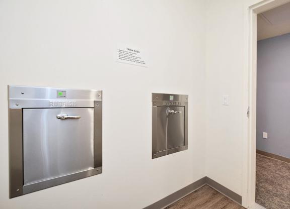 a kitchen with stainless steel appliances and a sign on the wall