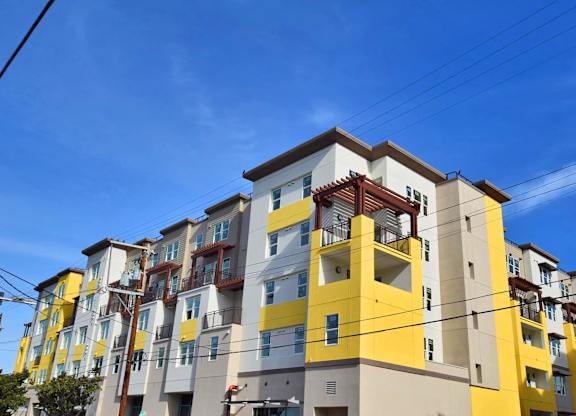 a colorful apartment building with power lines in front of it