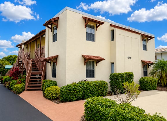 475 - BUILDING EXTERIOR - A two-story house with a staircase leading to the second floor.
