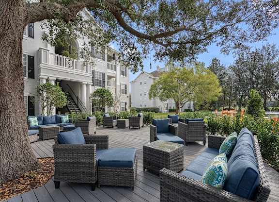 Quiet patio with seating under the shade of a large oak tree