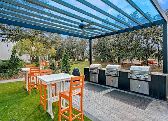 a patio with a table and chairs under a blue roof