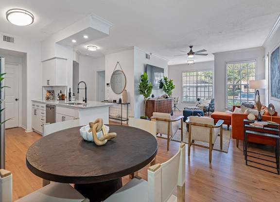 a living room with a dining room table and a kitchen