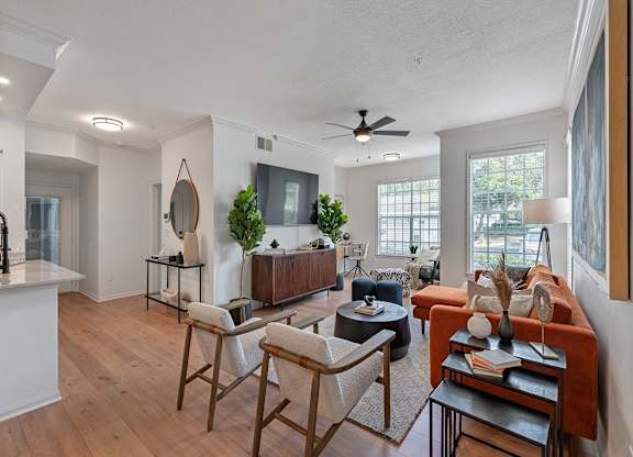 a living room with furniture and a ceiling fan