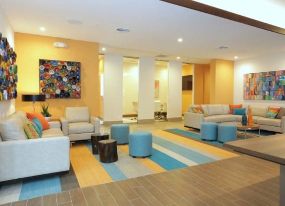 a lobby of a hotel with couches and chairs