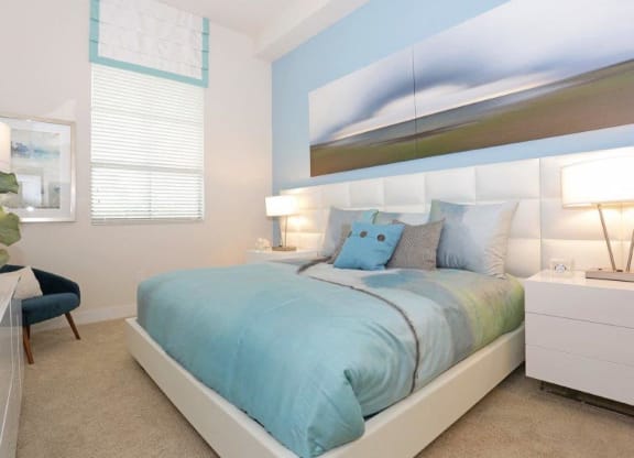 a blue and white bedroom with a bed