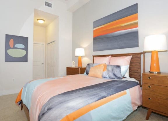 a bedroom with a bed and a painting on the wall