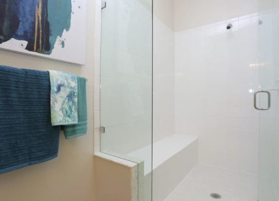 a bathroom with a shower and towels on a towel rack