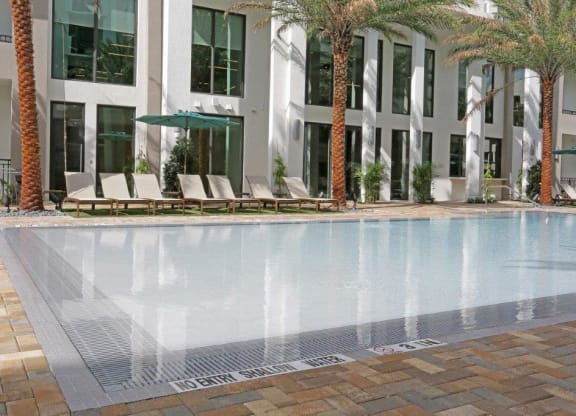 a swimming pool with a building in the background