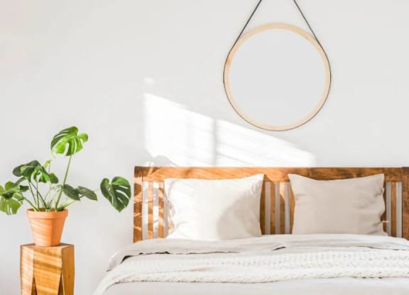 a bedroom with a bed and a mirror on the wall at Greenway Village Apartments, Metuchen, NJ, 08840