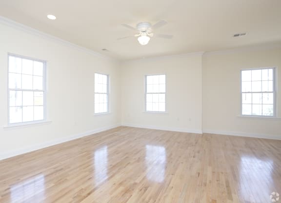 an empty room with a ceiling fan and three windows at Greenway Village Apartments, New Jersey, 08840