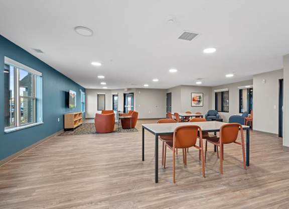 A room with a long table and chairs.