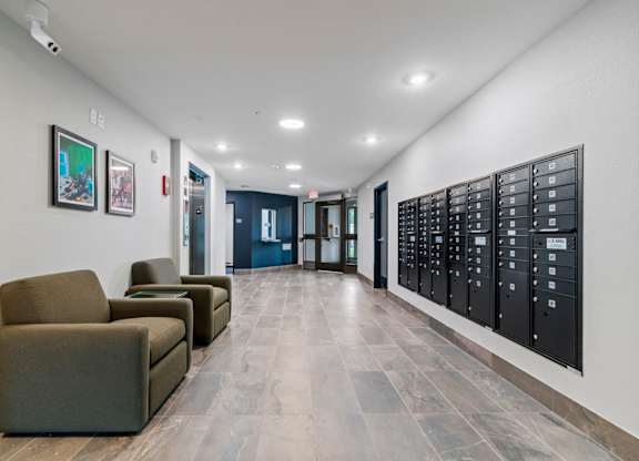 a hallway with chairs and a room with a vending machine