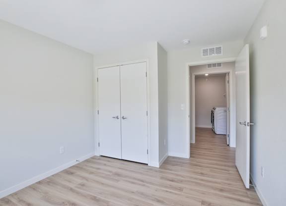 A room with a white door and a white cabinet.