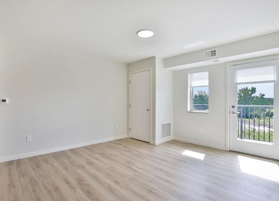 A room with a slanted ceiling and a window.
