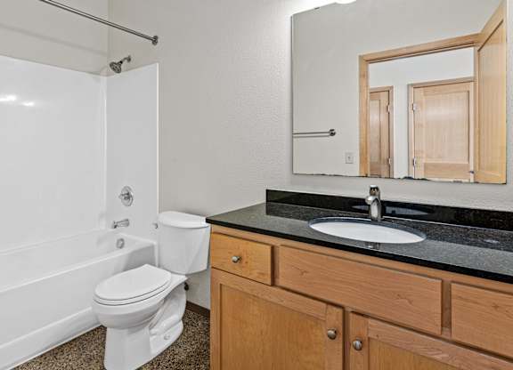 A white toilet sits next to a sink in a bathroom.